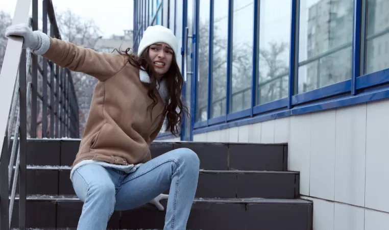 A woman slips on a stair