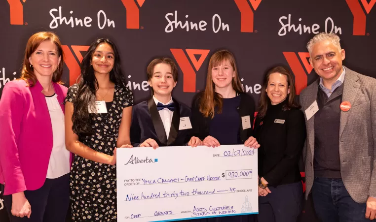 Minister Tanya Fir poses with Shannon Doram, President & CEO of YMCA Calgary and Adam Pekarsky, Chair of Love, Camp Capital Campaign pose with youth from YMCA Calgary during a cheque presentation for the Love, Camp campaign