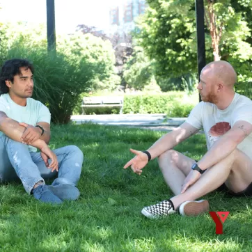 Men sitting on lawn chatting