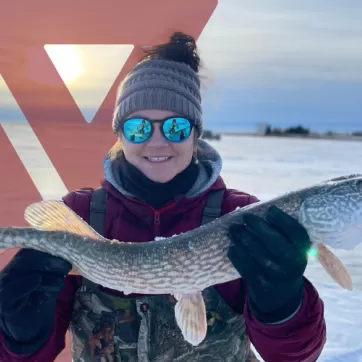 Tamara Lee holds up a fish she caught